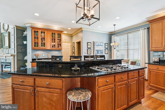 709 Pilot House Dr, Annapolis, MD 21401 - kitchen featuring an inviting chandelier, light wood-type flooring, a center island, stainless steel gas cooktop, and brown cabinetry