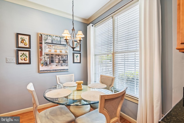 709 Pilot House Dr, Annapolis, MD 21401 - dining area with baseboards, ornamental molding, wood finished floors, and a chandelier