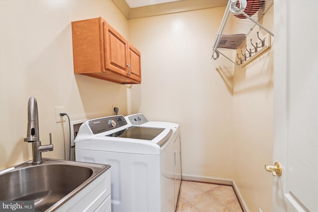 709 Pilot House Dr, Annapolis, MD 21401 - laundry area with washer and clothes dryer, a sink, baseboards, cabinet space, and light tile patterned floors