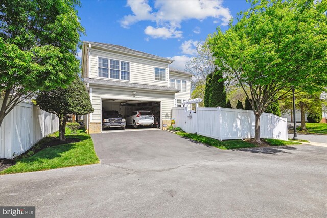 709 Pilot House Dr, Annapolis, MD 21401 - traditional-style house with fence, aphalt driveway, and a garage