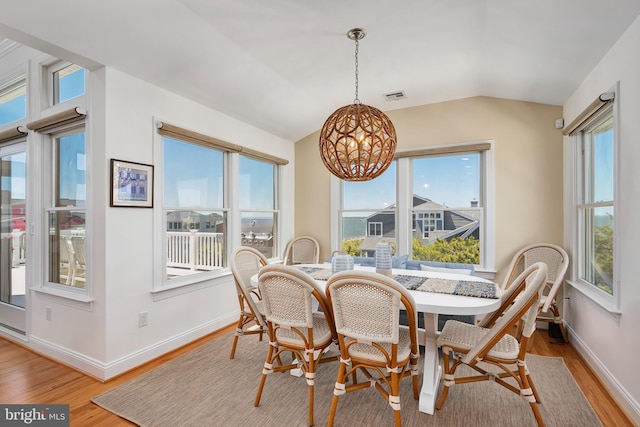 1082-E Long Beach Blvd, Long Beach Township, NJ 08008 - dining space featuring a chandelier, light wood-style flooring, baseboards, healthy amount of natural light, and vaulted ceiling