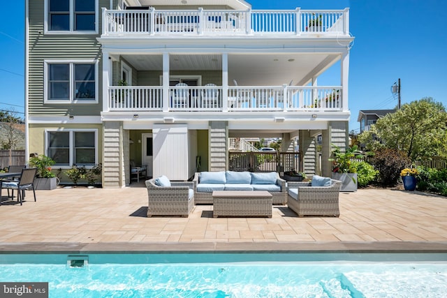 1082-E Long Beach Blvd, Long Beach Township, NJ 08008 - back of property with a balcony, an outdoor hangout area, stairs, a patio area, and an outdoor pool