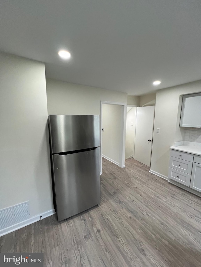 808 Division Ave NE, Washington, DC 20019 - kitchen featuring visible vents, baseboards, light wood-type flooring, freestanding refrigerator, and recessed lighting