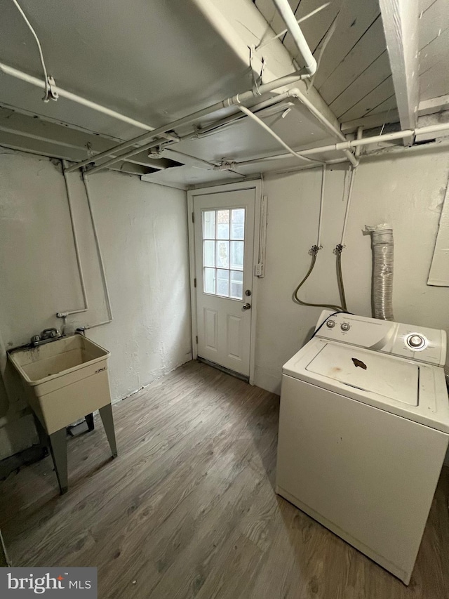 808 Division Ave NE, Washington, DC 20019 - clothes washing area featuring laundry area, wood finished floors, a sink, and washer / dryer