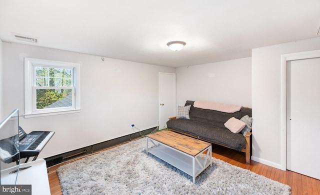 living area featuring wood finished floors and visible vents