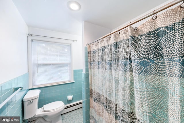 bathroom featuring a baseboard heating unit, wainscoting, tile walls, toilet, and a shower with shower curtain