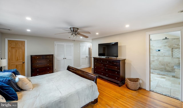 bedroom featuring connected bathroom, wood finished floors, visible vents, and recessed lighting