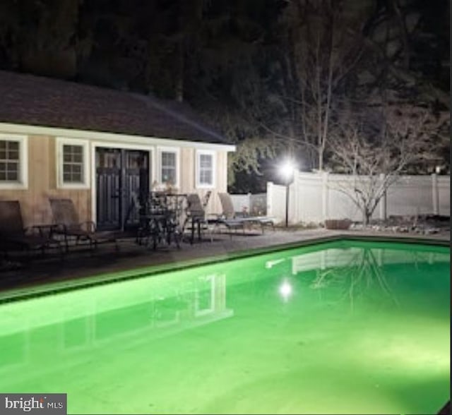 view of swimming pool featuring a fenced in pool and fence