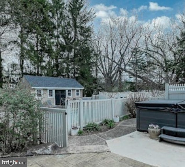 view of patio / terrace featuring a hot tub and fence private yard