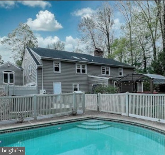 view of swimming pool featuring fence and a fenced in pool