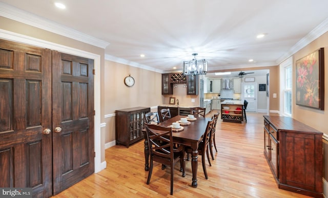 dining area with recessed lighting, ornamental molding, light wood-type flooring, baseboards, and a chandelier