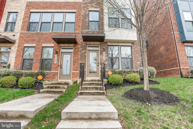 townhome / multi-family property with brick siding
