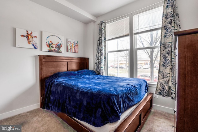bedroom with baseboards and carpet