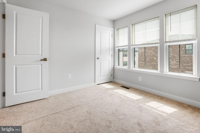 interior space with carpet flooring, visible vents, and baseboards