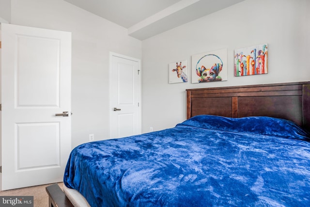 carpeted bedroom with vaulted ceiling