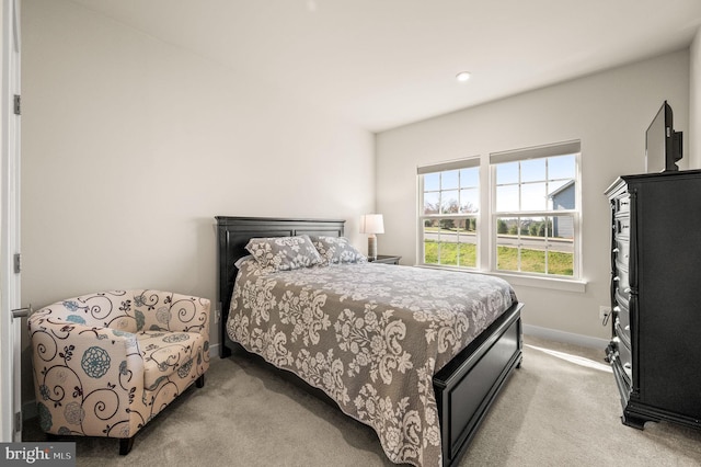 carpeted bedroom featuring baseboards