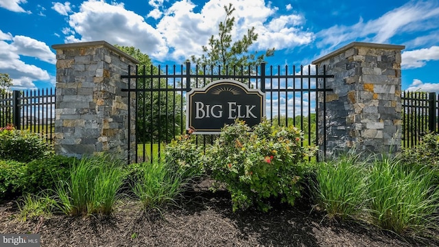 community sign featuring fence