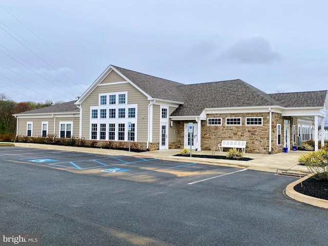view of building exterior featuring uncovered parking