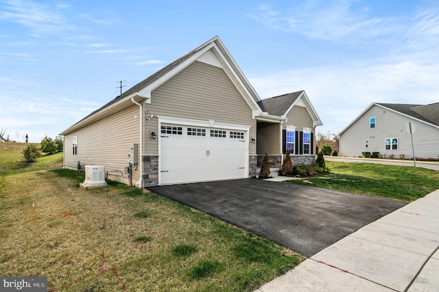 view of front of home featuring an attached garage, aphalt driveway, stone siding, and a front lawn