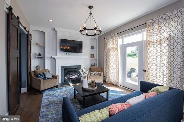 0 Philadelphia Ave, Boyertown, PA 19512 - living room featuring built in features, a large fireplace, a barn door, wood finished floors, and a notable chandelier