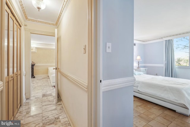 hall featuring crown molding and marble finish floor