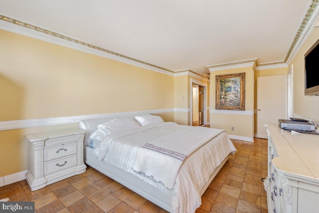 bedroom featuring baseboards and ornamental molding