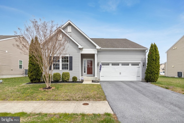 108 N Alnwick Ln, Millsboro, DE 19966 - view of front facade featuring a front yard, a shingled roof, a garage, and aphalt driveway
