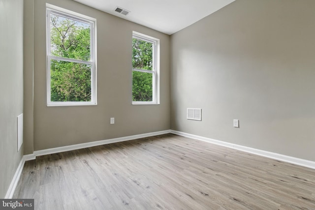 empty room with light wood-style floors and baseboards