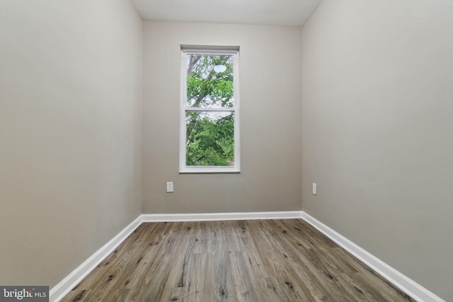 unfurnished room with wood finished floors and baseboards
