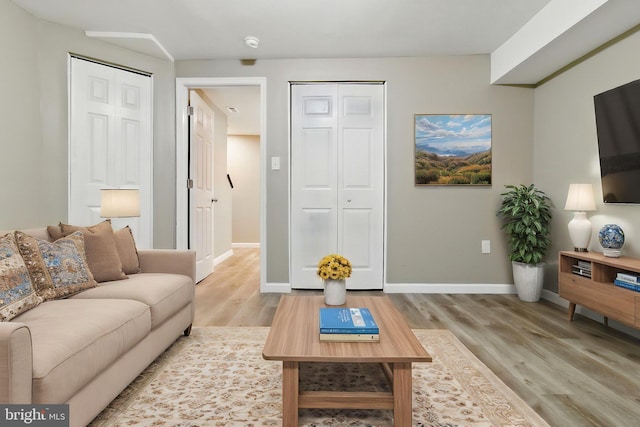 living area with wood finished floors and baseboards