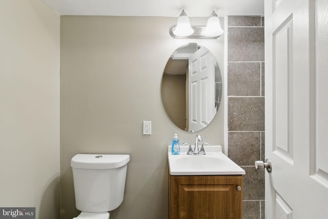 bathroom featuring toilet and vanity