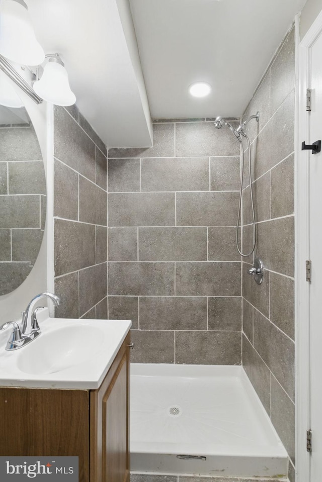 bathroom with vanity and a stall shower