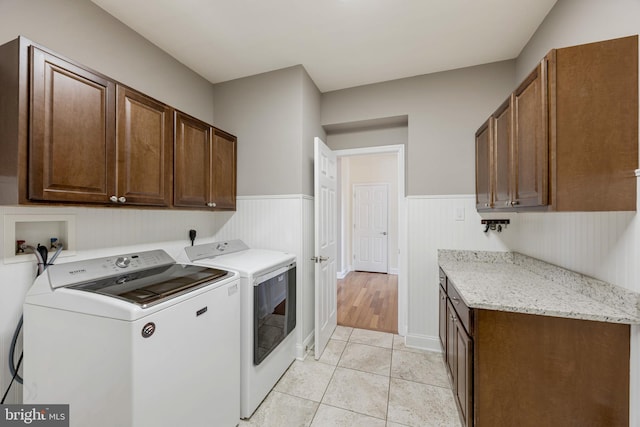 648 Green Valley Way, Sykesville, MD 21784 - laundry area featuring light tile patterned floors, independent washer and dryer, a wainscoted wall, and cabinet space
