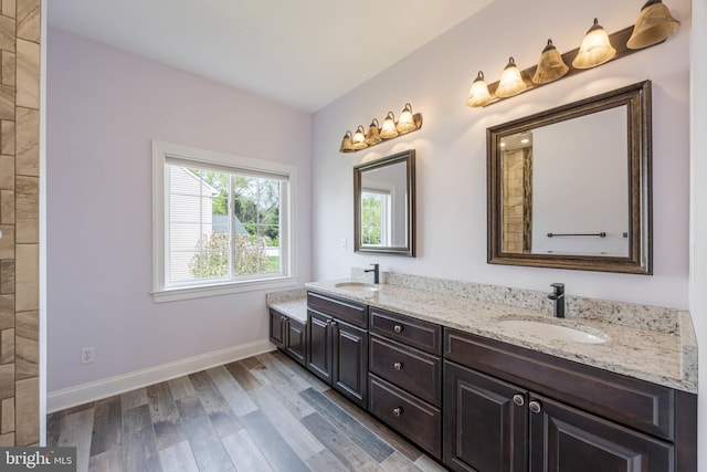 648 Green Valley Way, Sykesville, MD 21784 - full bath featuring double vanity, wood finished floors, baseboards, and a sink