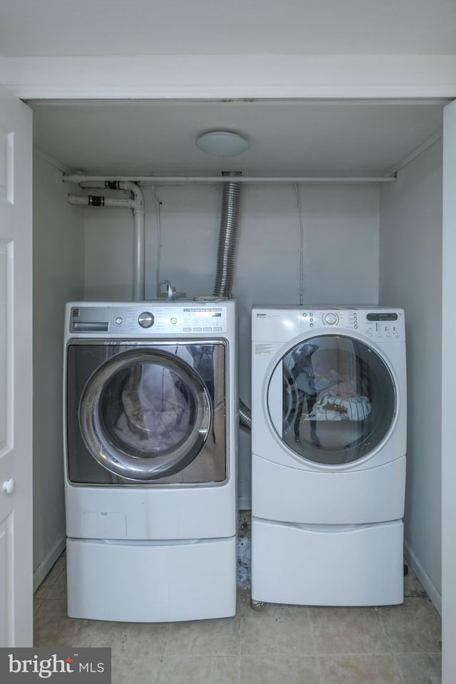 205 Polk Ave, Front Royal, VA 22630 - laundry area featuring separate washer and dryer, tile patterned floors, and baseboards