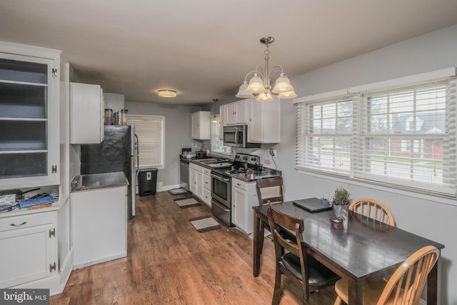 205 Polk Ave, Front Royal, VA 22630 - kitchen featuring appliances with stainless steel finishes, a chandelier, dark wood-style flooring, white cabinets, and dark countertops