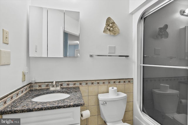 5401 Coastal Hwy Unit 306, Ocean City, MD 21842 - full bath with toilet, vanity, wainscoting, and tile walls