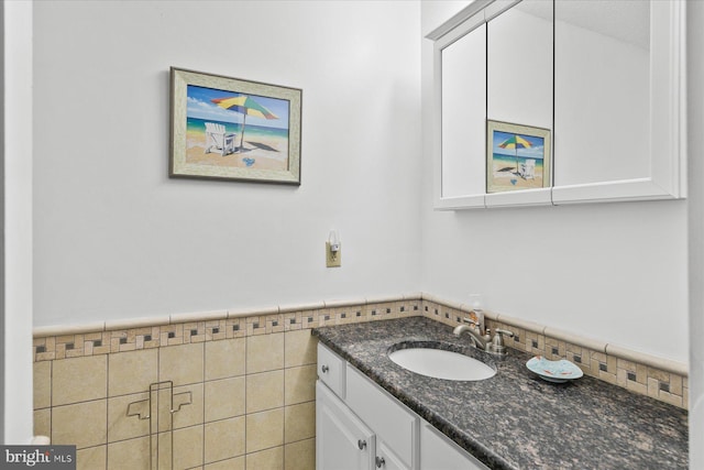 5401 Coastal Hwy Unit 306, Ocean City, MD 21842 - bathroom with tile walls, vanity, and a wainscoted wall