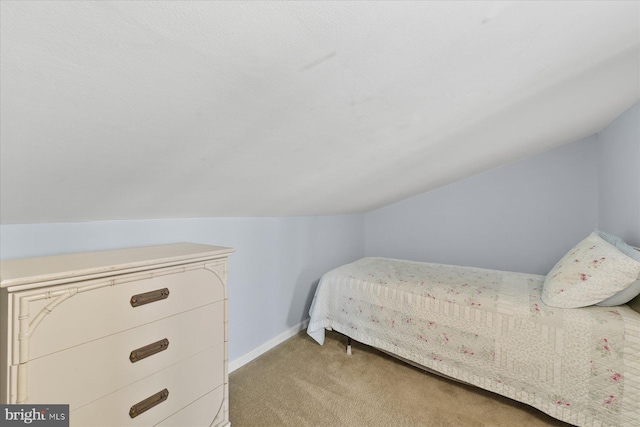 5401 Coastal Hwy Unit 306, Ocean City, MD 21842 - bedroom featuring baseboards, light colored carpet, and vaulted ceiling