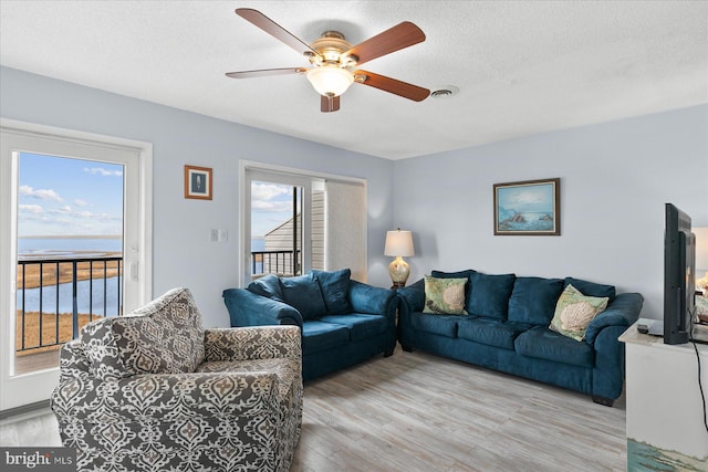 5401 Coastal Hwy Unit 306, Ocean City, MD 21842 - living room featuring visible vents, a ceiling fan, wood finished floors, and a textured ceiling