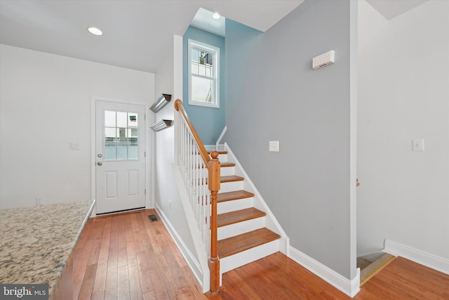 interior space featuring recessed lighting, stairway, light wood-style flooring, and baseboards