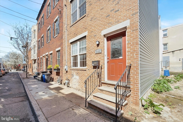 entrance to property with brick siding