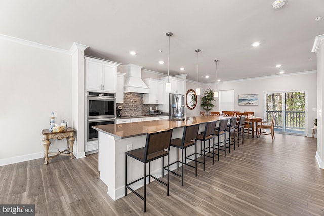 12435 Sea Oaks Ln Unit 3, Berlin, MD 21811 - kitchen with custom range hood, a kitchen breakfast bar, backsplash, a spacious island, and stainless steel appliances