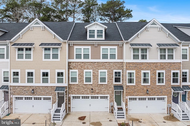 12435 Sea Oaks Ln Unit 3, Berlin, MD 21811 - view of property featuring an attached garage, roof with shingles, concrete driveway, and stone siding