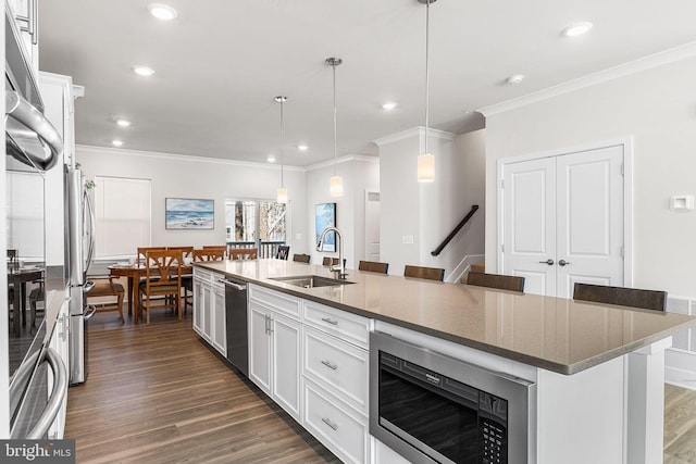 12435 Sea Oaks Ln Unit 3, Berlin, MD 21811 - kitchen featuring dark wood finished floors, white cabinetry, a sink, and appliances with stainless steel finishes