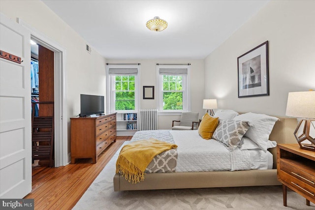 bedroom featuring light wood-style floors