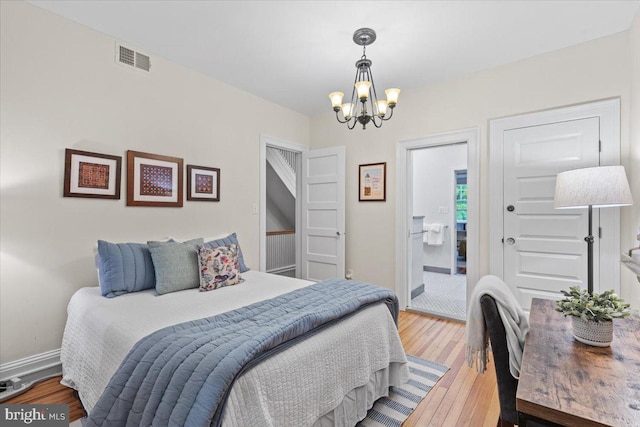 bedroom featuring a chandelier and hardwood / wood-style flooring