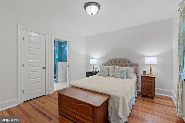 bedroom featuring light wood-style floors and baseboards