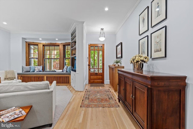 entrance foyer with crown molding, light wood-style floors, healthy amount of natural light, and recessed lighting