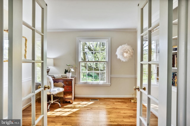 office with crown molding, wood finished floors, french doors, baseboards, and visible vents